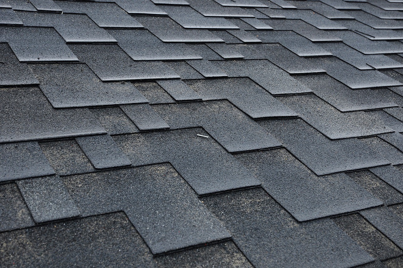 Close up view on Asphalt Roofing Shingles Background. Roof Shingles - Roofing.